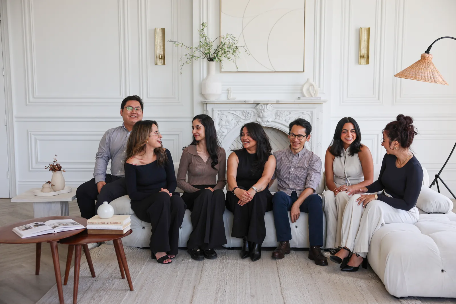 The Our Space Clinic team laughing together on the sofa.
