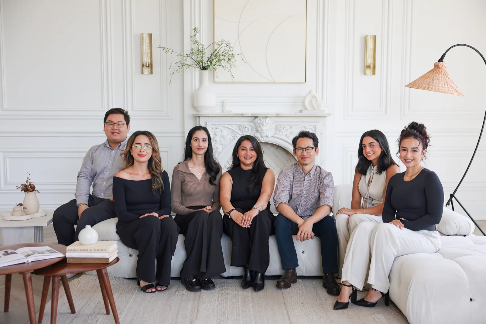 The Our Space Clinic team seated together in a bright, sunlit living room.